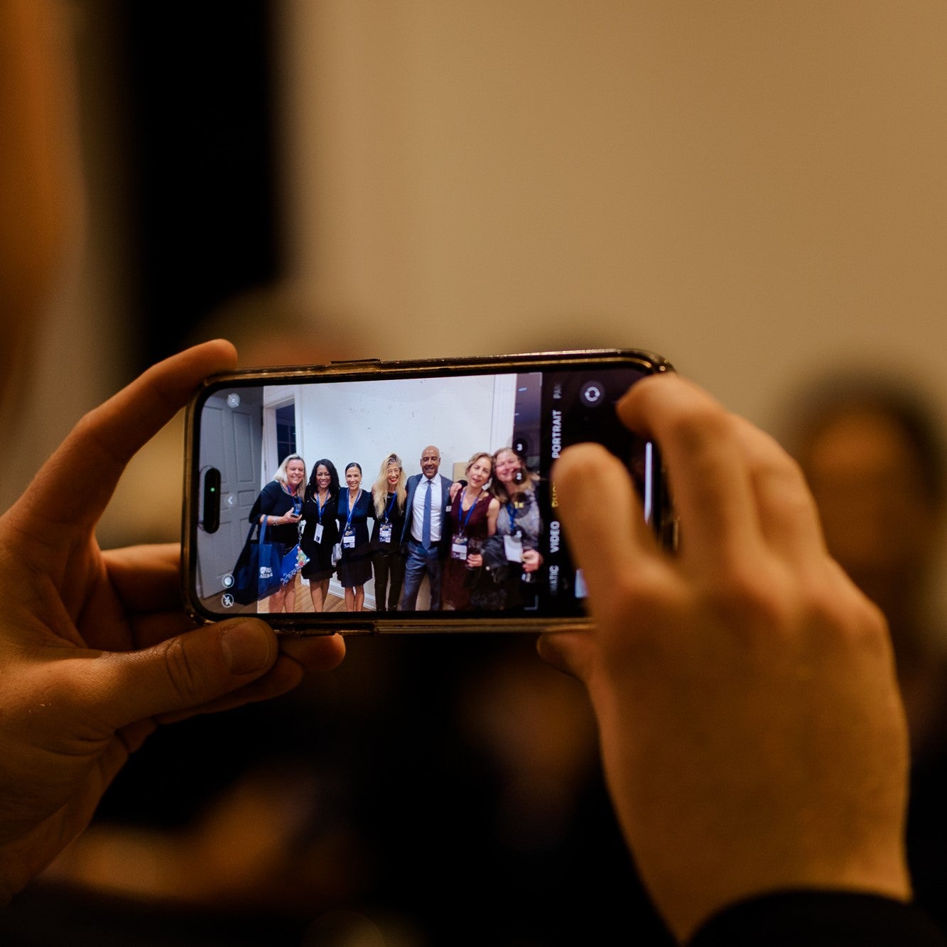 Hands holding phone taking a picture