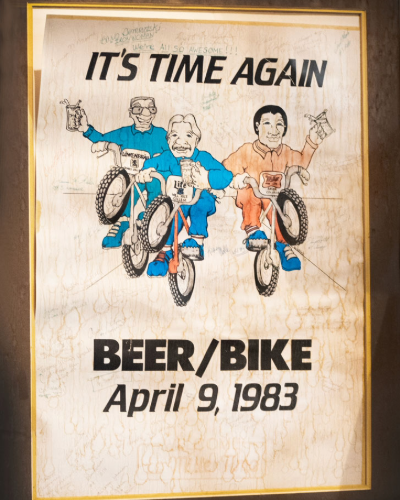 A Beer Bike poster from 1983 hangs in Will Rice College