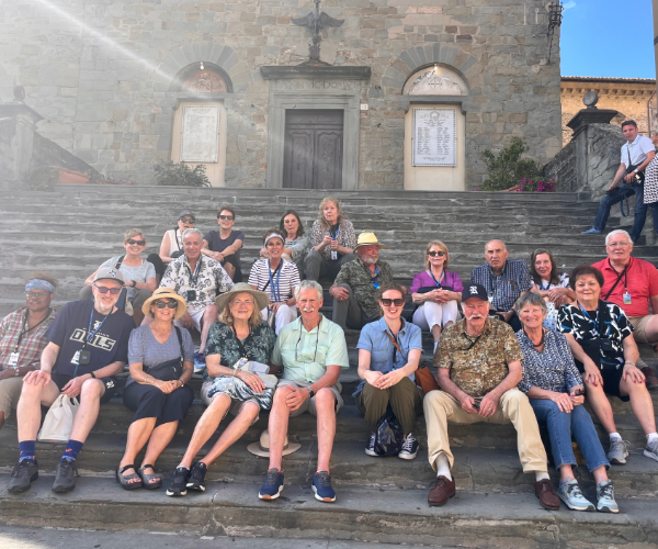 group sitting on the steps od Cortona basilica